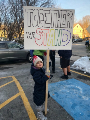 Lori's daughter holds a sign that reads "Together we stand" at the 2018 Women's March.